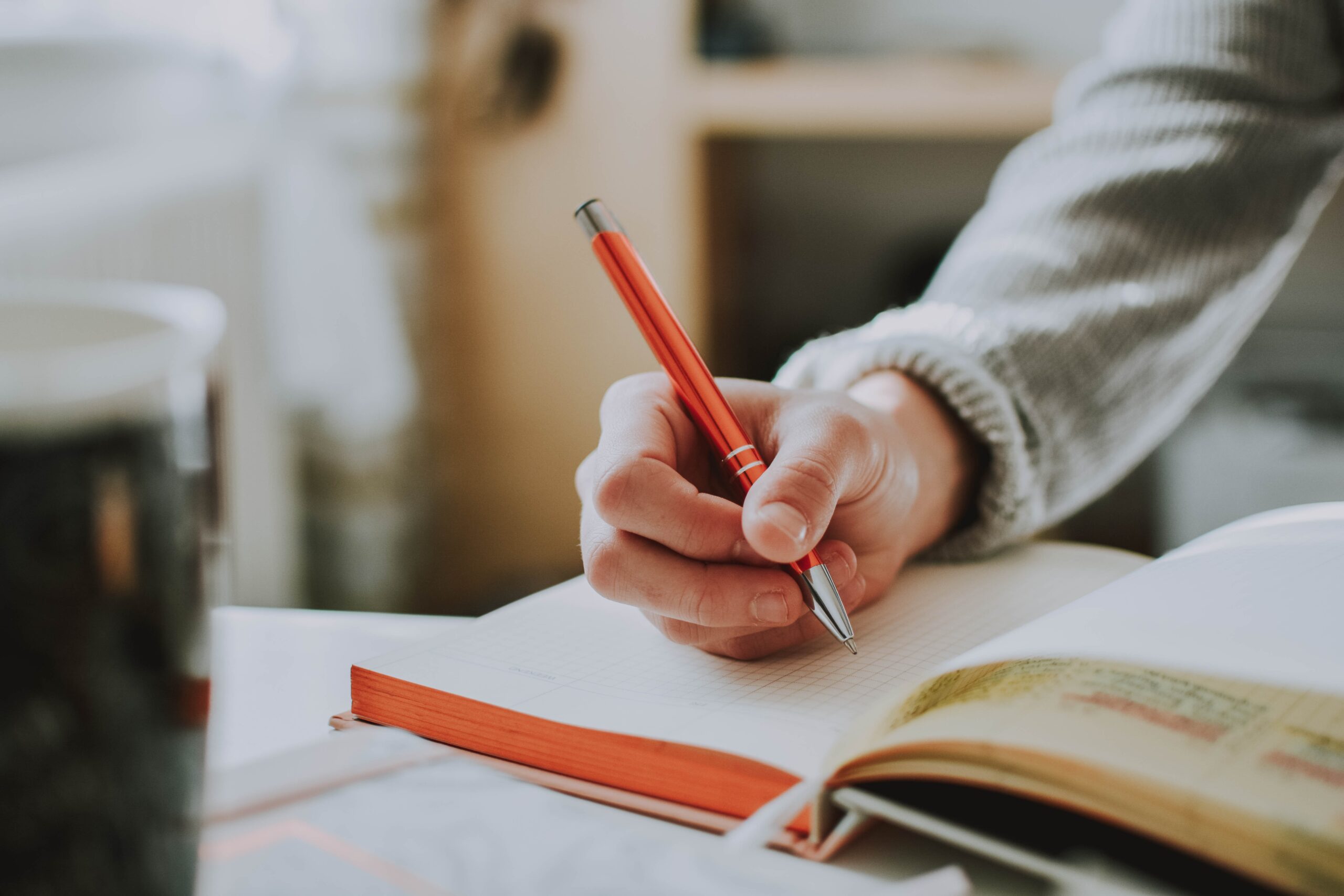 Hand writing notes in a pad